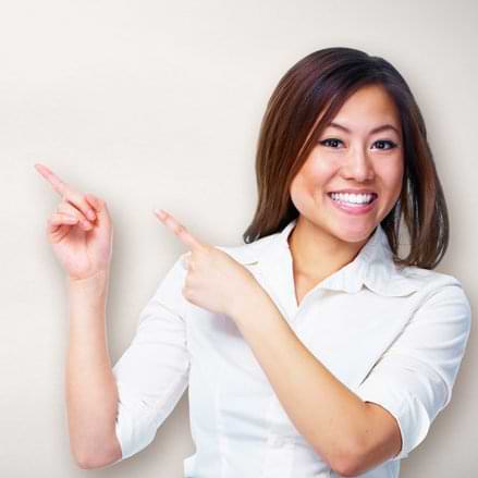 Happy woman pointing pointing to her right at the solution for her problems