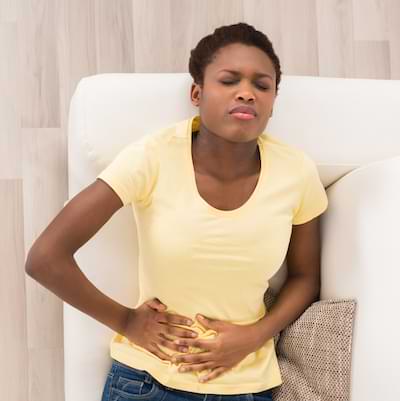 Woman experiencing abdominal pain