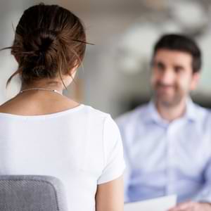 Women in exam room talking to gynecologist 